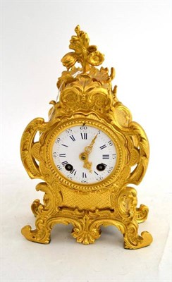 Lot 130 - A 19th century French gilt metal rococo scrolling mantel clock with white enamel dial and blue...