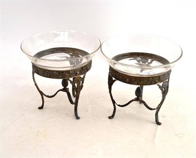 Lot 134 - A pair of late Victorian silver preserve dish stands, the circular foliate repousse frames on three