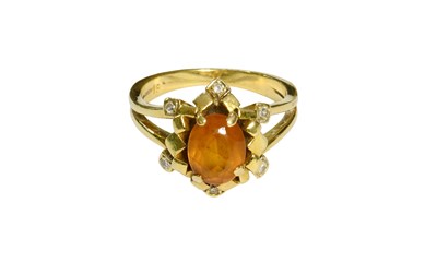Lot 527 - A Citrine and Diamond Cluster Ring, the oval...