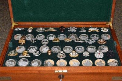 Lot 166 - A cased set of fifty two sterling silver Great British Regiments, each of 1.43oz, with...