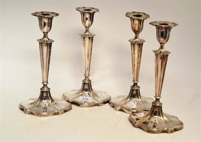 Lot 234 - A set of four Walker & Hall plated candlesticks