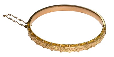 Lot 339 - A 9 Carat Gold Bangle, the front with engraved...