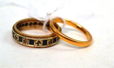 Lot 288 - A 22ct gold band ring and an eternity ring