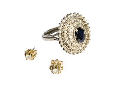 Lot 330 - A Sapphire and Diamond Cluster Ring, the oval...