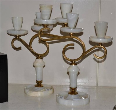 Lot 376 - Pair of gilt three branch candle holders on circular bases