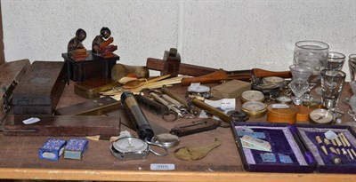 Lot 385 - Box of glasses, box of assorted compasses etc, tools, balances, cased sewing set, bag of bone...