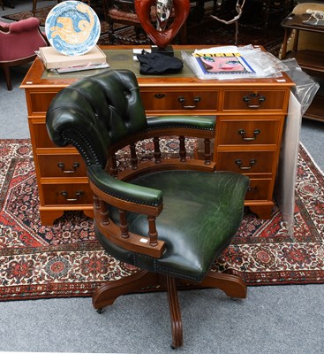 Lot 1521 - A Reproduction Yew Kneehole Desk, with green...