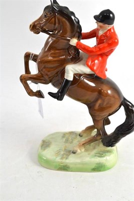 Lot 421 - Beswick huntsman on bay rearing horse