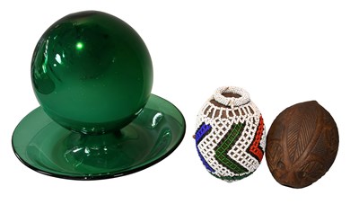 Lot 124 - A Green Glass Witches Ball on Stand; a tribal...