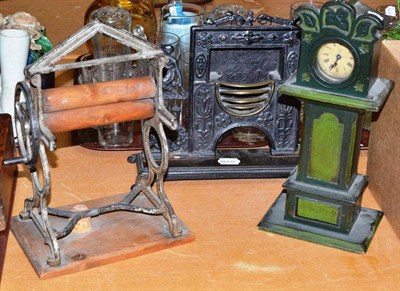 Lot 444 - A 19th century cast-iron model chimneypiece, a model mangle and a wooden longcase clock