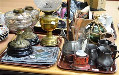 Lot 445 - Three brass oil lamps, one shade, pewter, red-painted candle holder, pottery making tools, box...