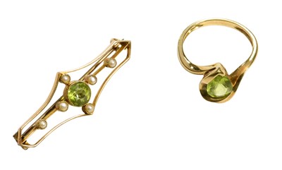 Lot 454 - A Peridot Ring, the pear cut peridot in a...