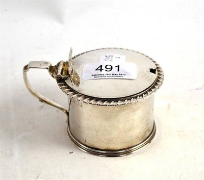 Lot 491 - A Georgian silver mustard pot with blue glass liner (marks worn)