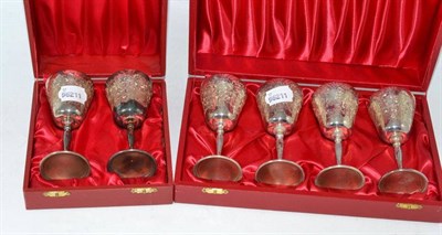 Lot 503 - Set of six engraved silver small goblets (in two cases)