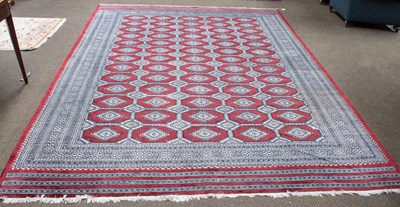 Lot 1285 - "Bukhara" Carpet, the claret lattice field of...