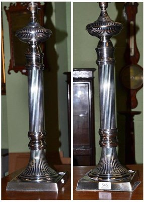 Lot 545 - A pair of tall fluted silver plated table lamps