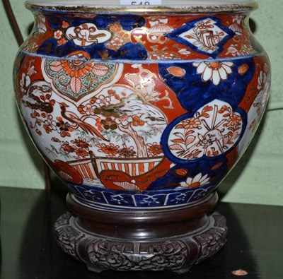 Lot 548 - A Japanese Imari cache pot on hardwood stand