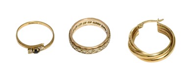 Lot 455 - A 9 Carat Gold Sapphire and Diamond Twist Ring,...