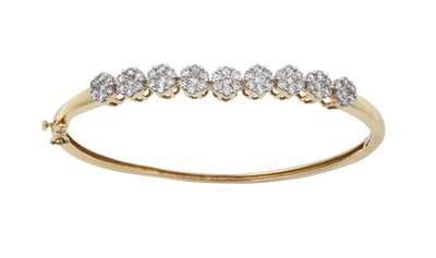 Lot 2271 - A Diamond Cluster Hinged Bangle nine clusters...