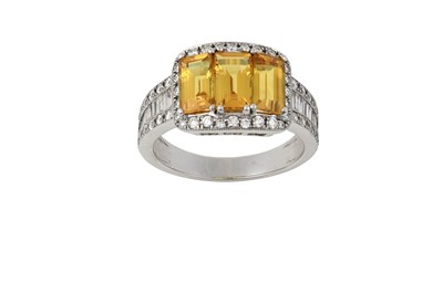Lot 2233 - A Yellow Sapphire and Diamond Ring three...