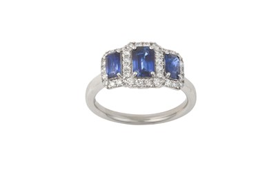 Lot 2299 - A Sapphire and Diamond Cluster Ring three...