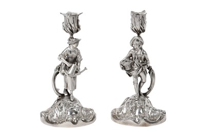 Lot 2130 - A Pair of Victorian Silver Figural Candlesticks