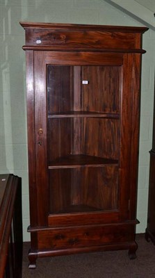 Lot 654 - A reproduction carved hardwood glazed floor standing corner cabinet