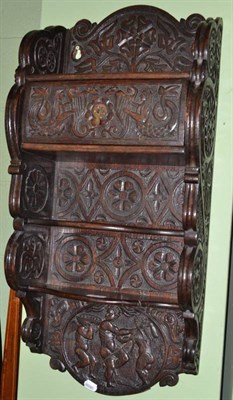 Lot 657 - Carved oak hanging shelves