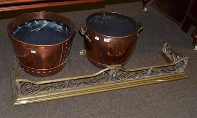 Lot 706 - A copper and brass log bin on three paw feet, another copper log bin, a brass fender, a copper...