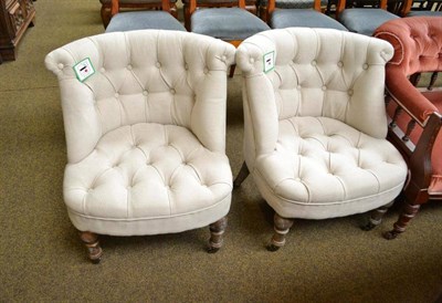 Lot 740 - A pair of beige upholstered tub shape chairs