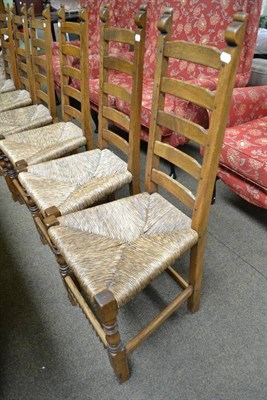 Lot 749 - A set of six oak ladder back chairs with rush seats