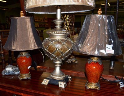 Lot 767 - A large silver painted table lamp and two other small painted table lamps