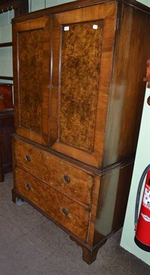 Lot 807 - An early 20th century walnut linen chest in George II style with hanging space above two deep...