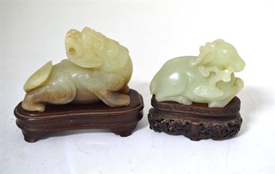 Lot 232A - A Chinese Celadon Jade Type Figure of a Goat, recumbent eating fungus, 8cm; and A Similar Figure of