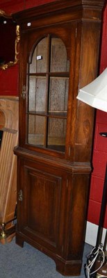 Lot 826 - A reproduction oak floor standing corner cabinet, 191cm high