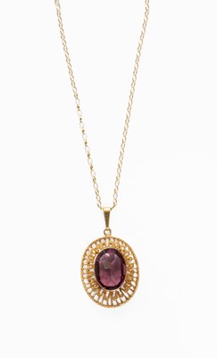 Lot 23 - A Purple Glass Pendant on Chain, the oval cut...