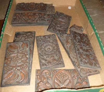 Lot 908 - Two wooden painted plaques with armorials and a collection of carved wooden plaques/panels