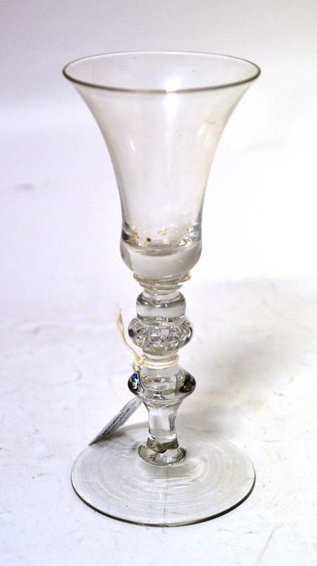 Lot 6 - A Baluster Wine Glass, circa 1740, the bell shape bowl over an acorn and blade knopped stem and...