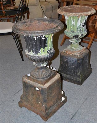 Lot 955 - A pair of 19th century cast iron urns on bases