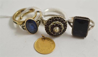Lot 60 - A one dollar coin, a 9ct gold ring and four assorted rings