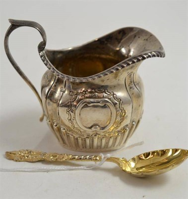 Lot 63 - Ornate late Victorian silver cream jug and a silver gilt spoon