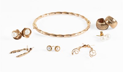 Lot 131 - A Bangle, of twist form, with applied plaque...
