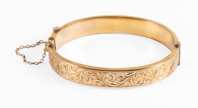 Lot 68 - A 9 Carat Gold Bangle, with an engraved upper...
