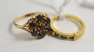 Lot 80 - A garnet ring stamped 9ct (a.f.) and an emerald and diamond ring stamped 18ct (a.f.)