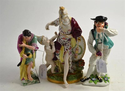 Lot 90 - Berlin porcelain figure of a man on square base, a figure of a grape harvester and a group of...