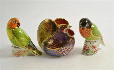 Lot 97 - Three Royal Crown Derby paperweights ''Black faced love bird'', ''Red faced love bird'' and a...