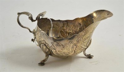 Lot 107 - Georgian Irish embossed silver sauceboat