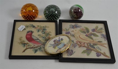 Lot 171 - Two framed needlework pictures of birds, a small oval needlework of flowers and three paperweights