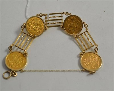 Lot 193 - A 9ct gold gate bracelet loose mounted with four sovereigns: dated 1892, 1905, 1928 and 1966