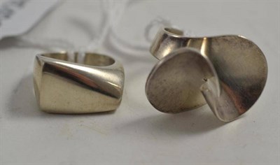 Lot 195 - A silver ring by Georg Jensen of asymmetric form, model number 141, finger size L; and another...